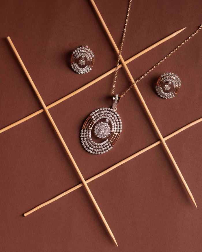 Elegant diamond jewelry set featuring a necklace and earrings on a brown backdrop.