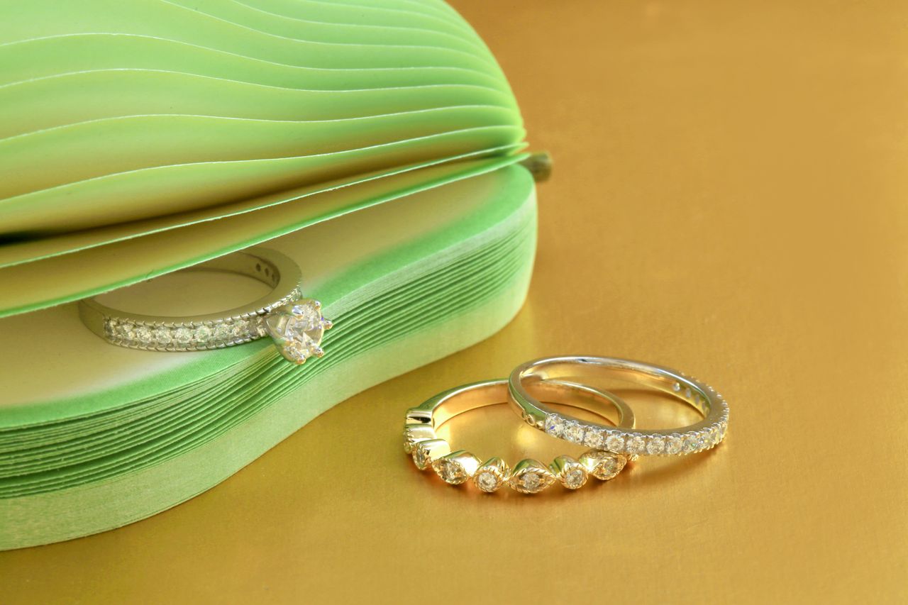 The Art of Drawing Readers In: Your attractive post title goes here Elegant diamond rings displayed on a gold surface with a chic design.